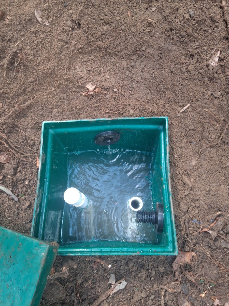 Open access box with water and PVC fittings.