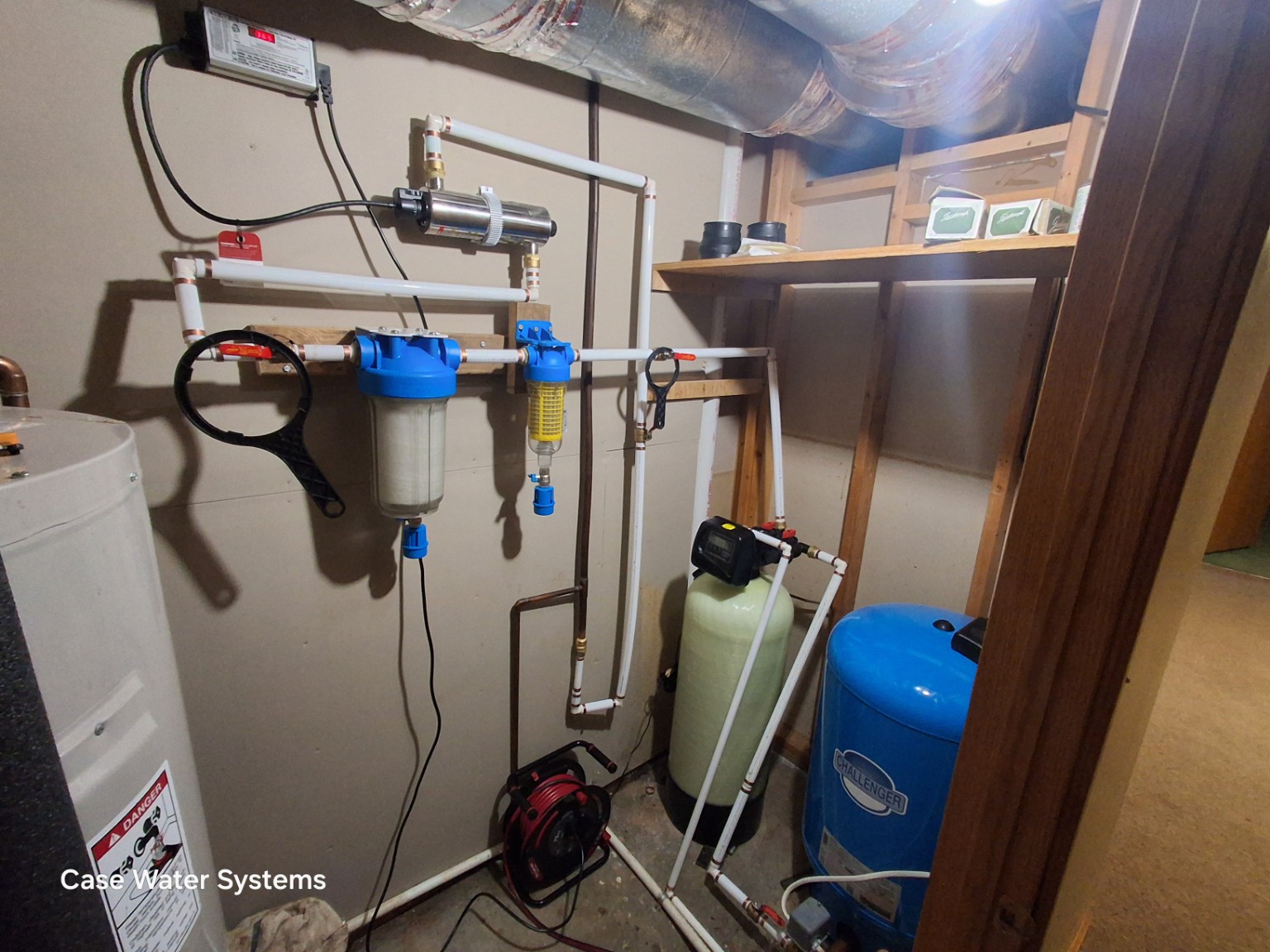 Water filtration housings, UV treatment unit and pressure tank installed in a utility room